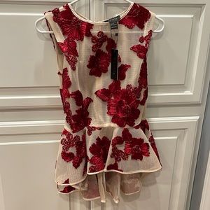 Large Garcia peplum top. Beautiful, detailed red flower embroidery. Heavy Mesh.